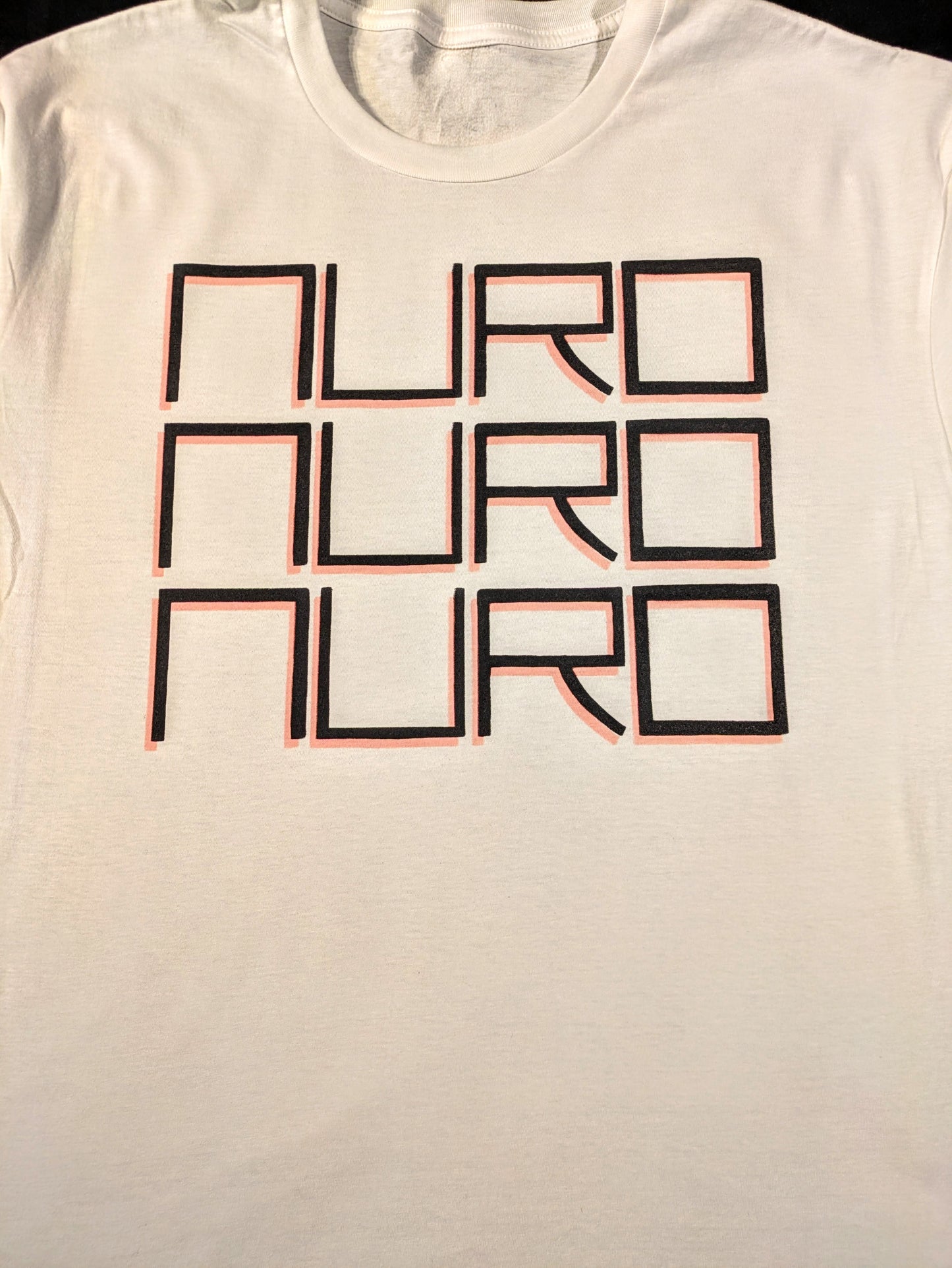 White t-shirt with 'NURO' text printed in black with a red dropshadow in fine block lettering