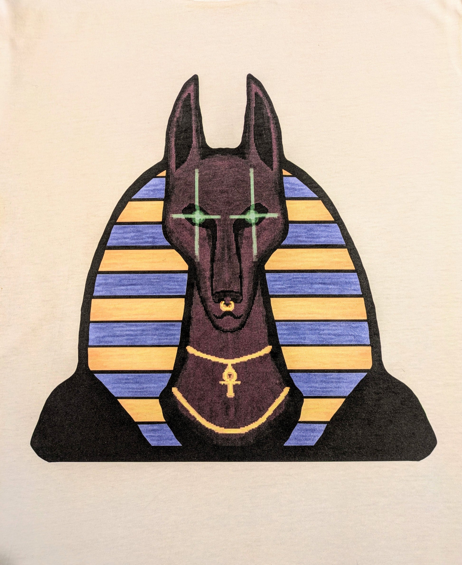 Design of a stylized version of Anubis with Egyptian-style striped headress and glowing reflective green eyes