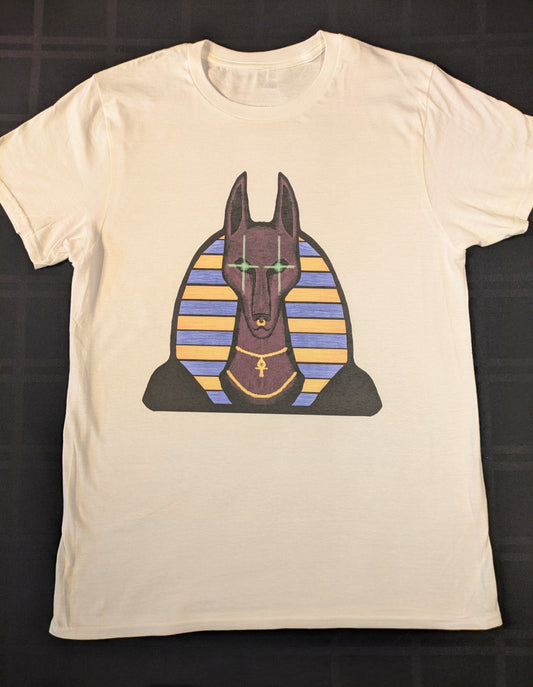 White t-shirt with an Egyptian-themed graphic design of Anubis with glowing green eyes