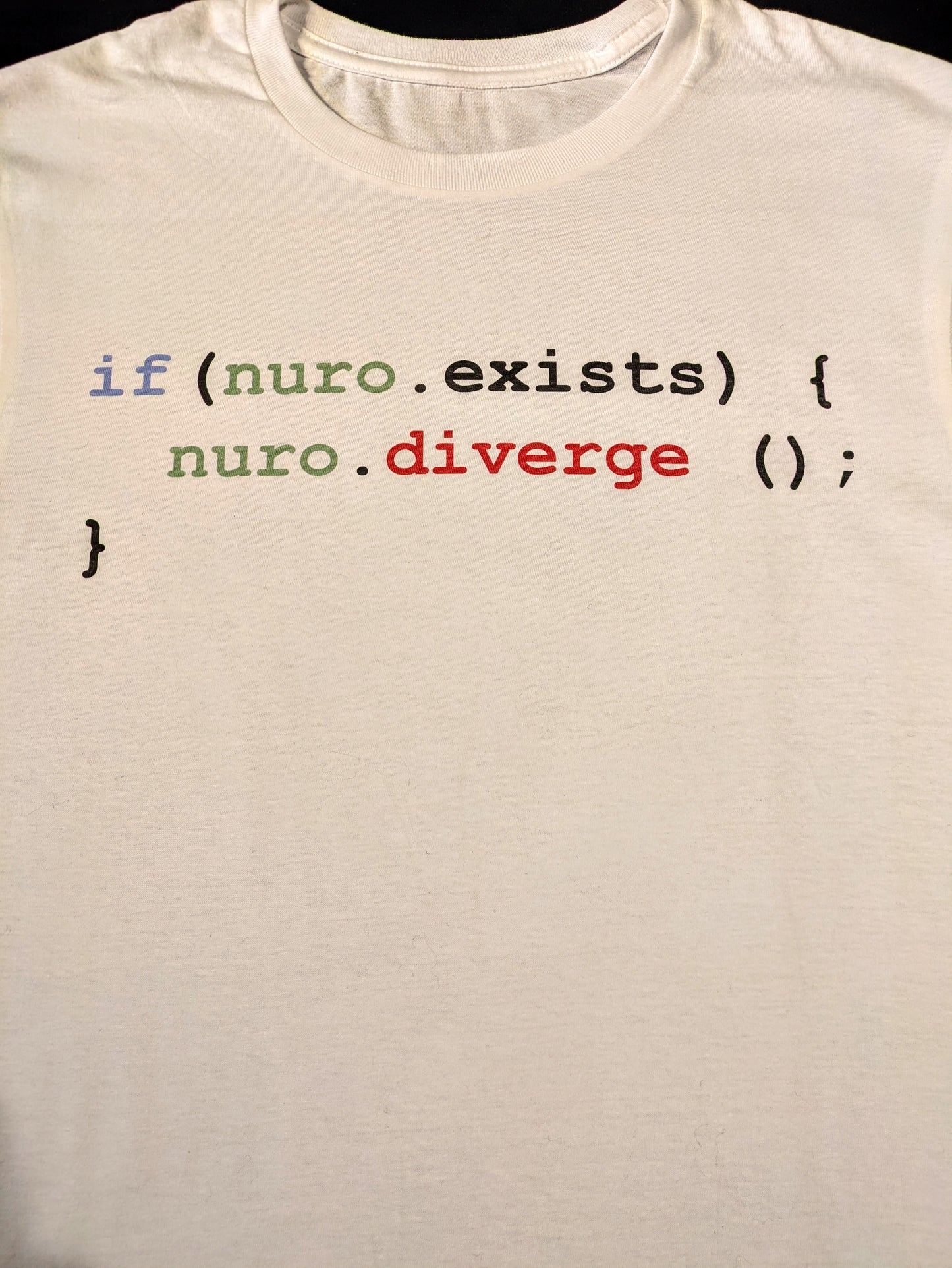 White tee with java code in syntax color stating that if nuro exists then nuro must diverge
