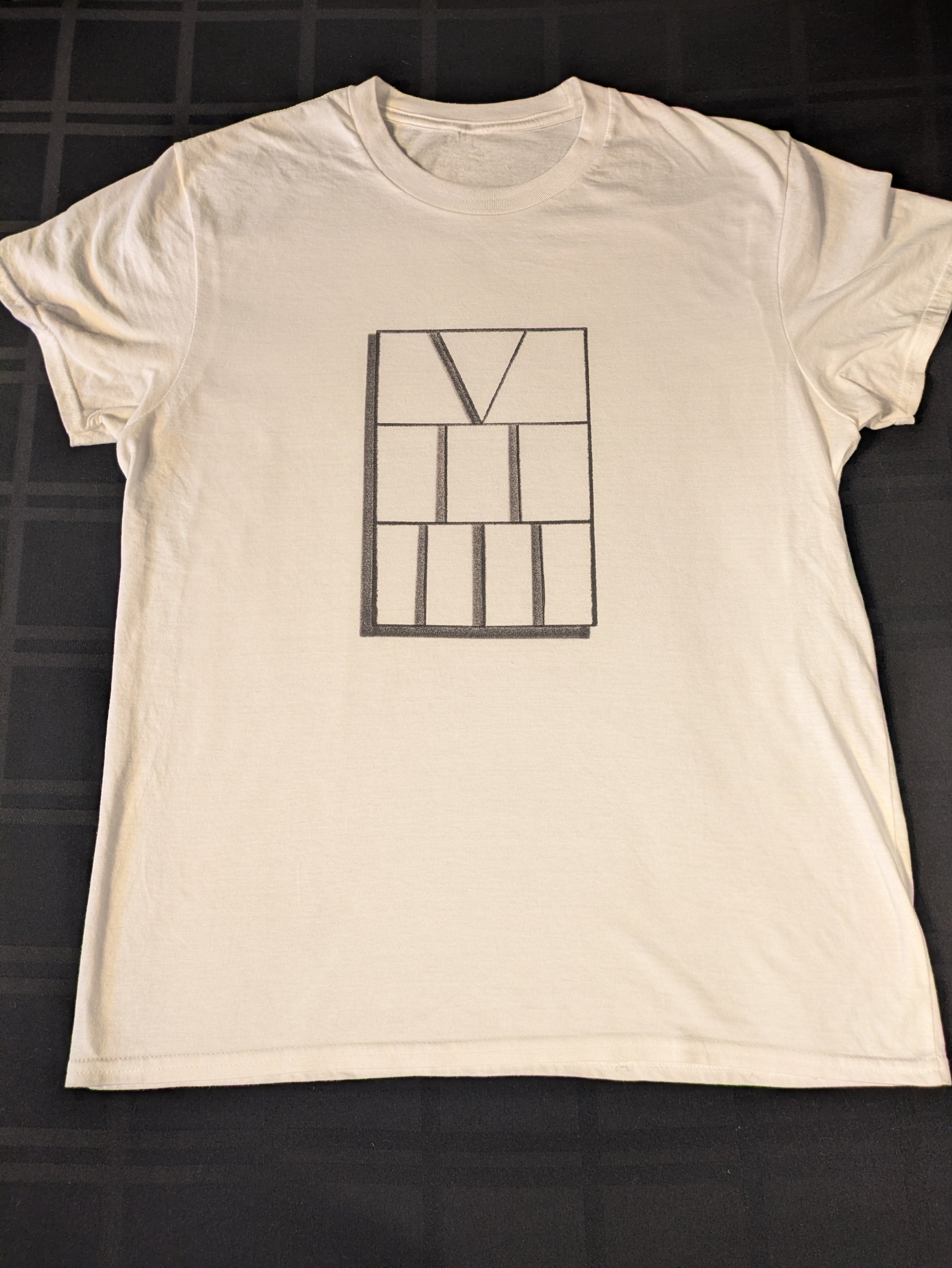 White t-shirt with rectangle at center with roman numerals five two three aligned vertically inside the rectangle 
