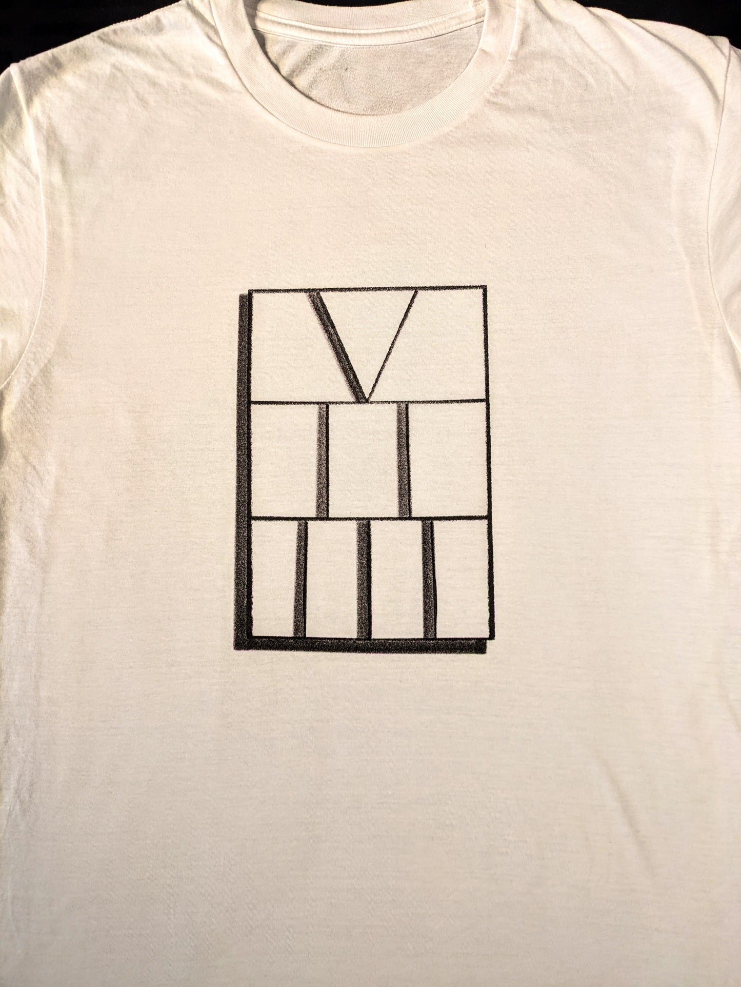 White tee with drop shadow rectangle featuring numbers five two three aligned vertically in roman numerals
