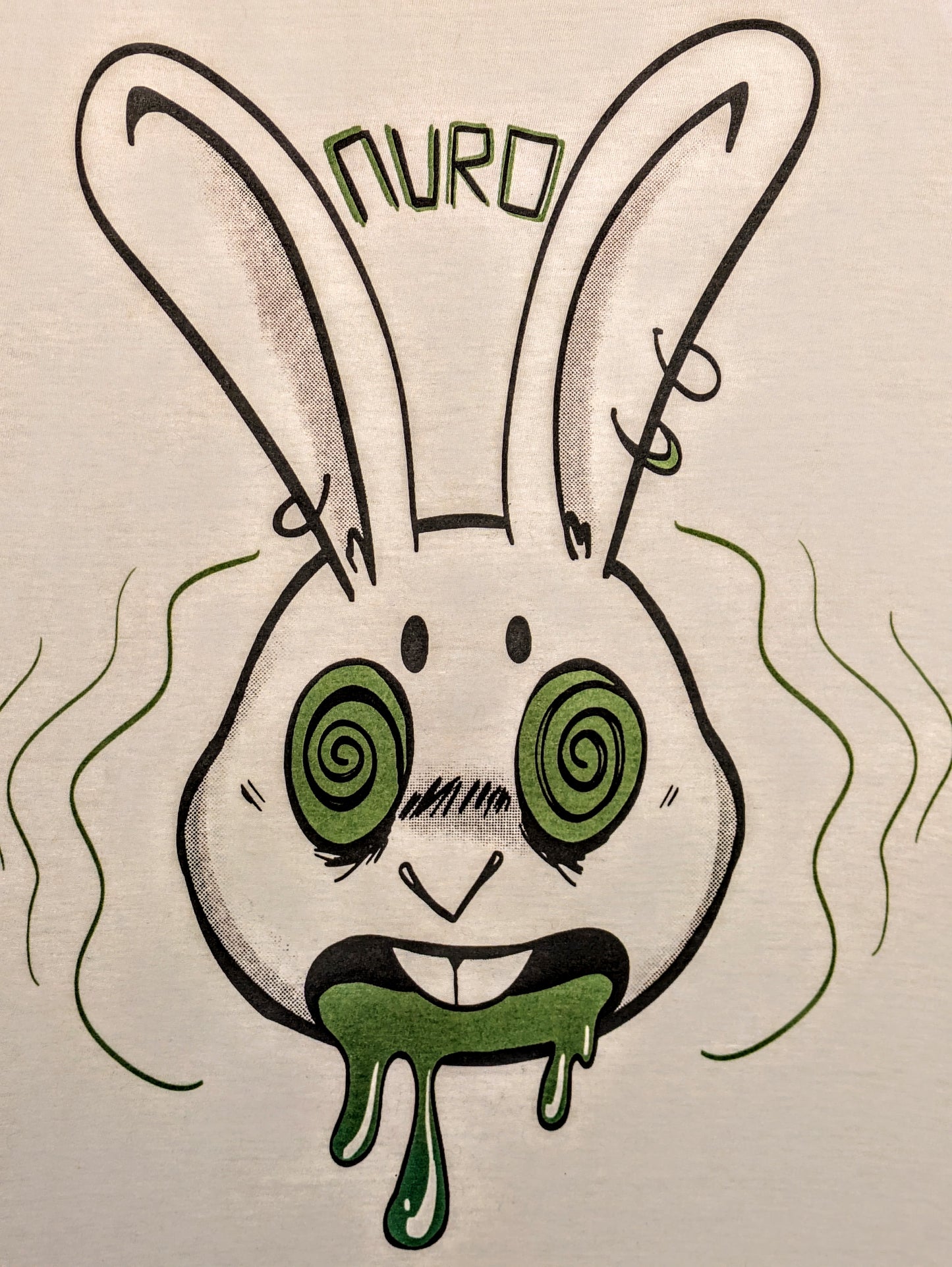 Cartoon anthro rabbit with pierced ears, green hypnotized eyes, an open mouth and green drool. Block lettering above spelling Nuro.