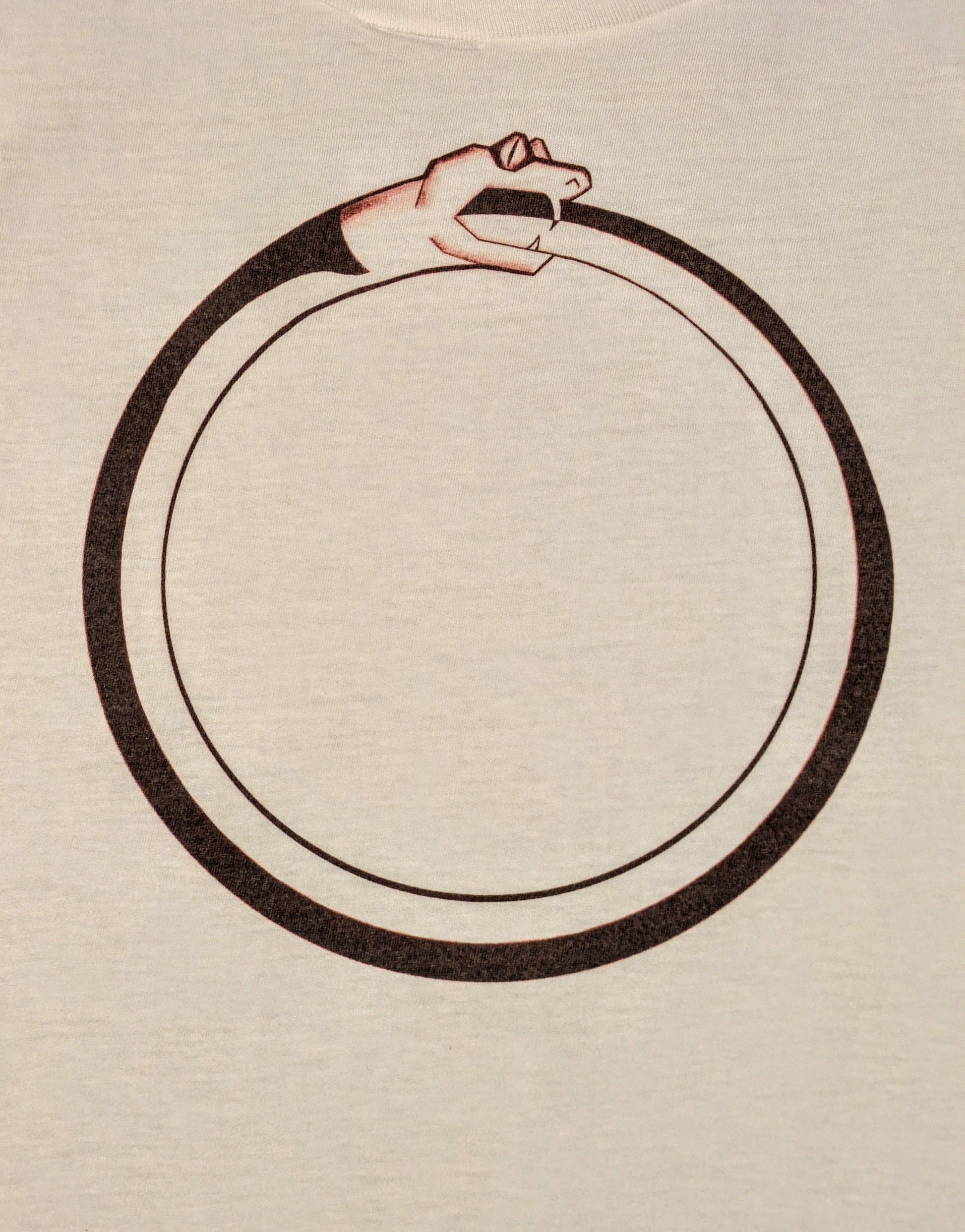 White t-shirt with a black circular design of a snake eating its own tail