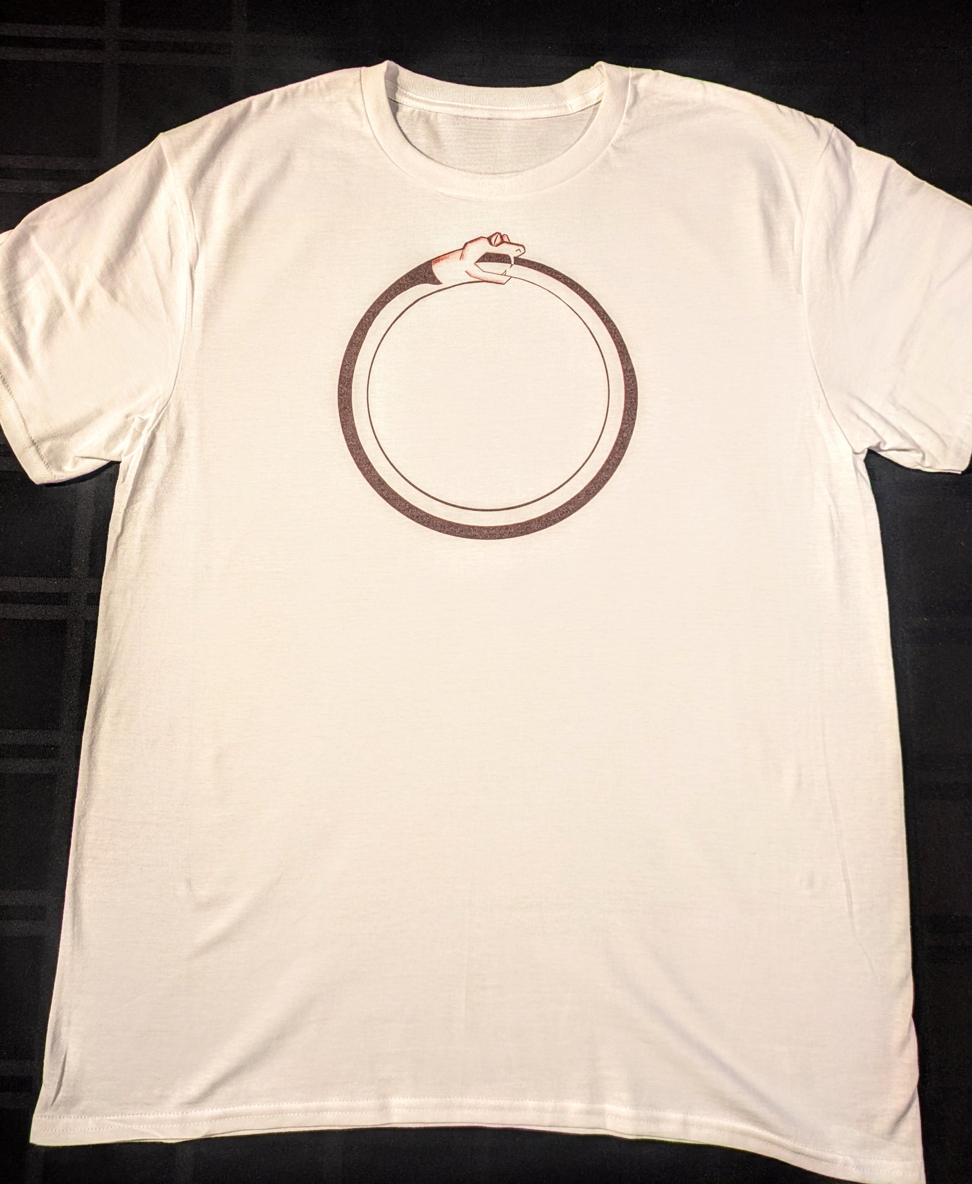 White t-shirt with a black circular design of a snake eating its own tail