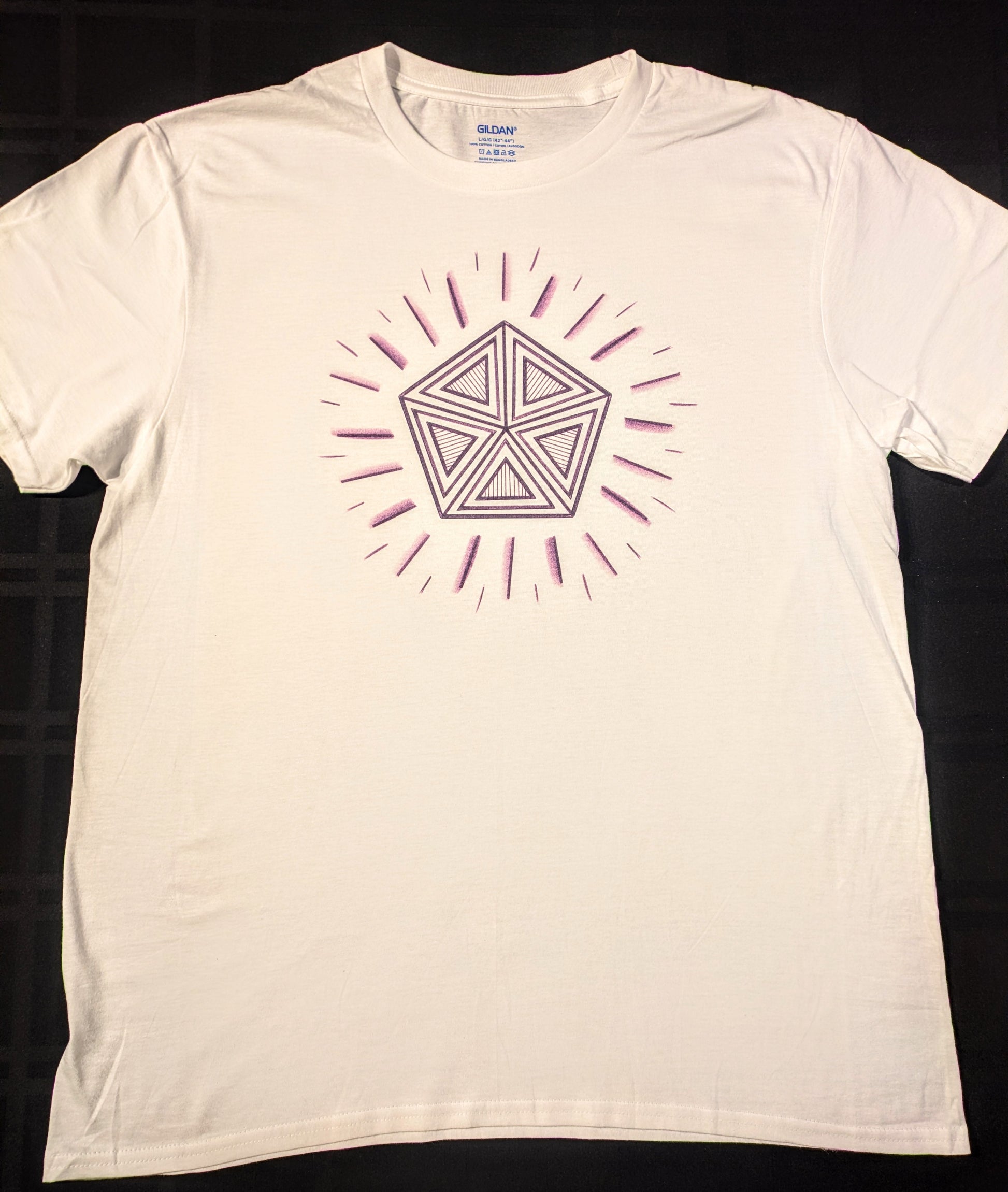 White t-shirt with geometric design of a purple pentagon and radiant lines
