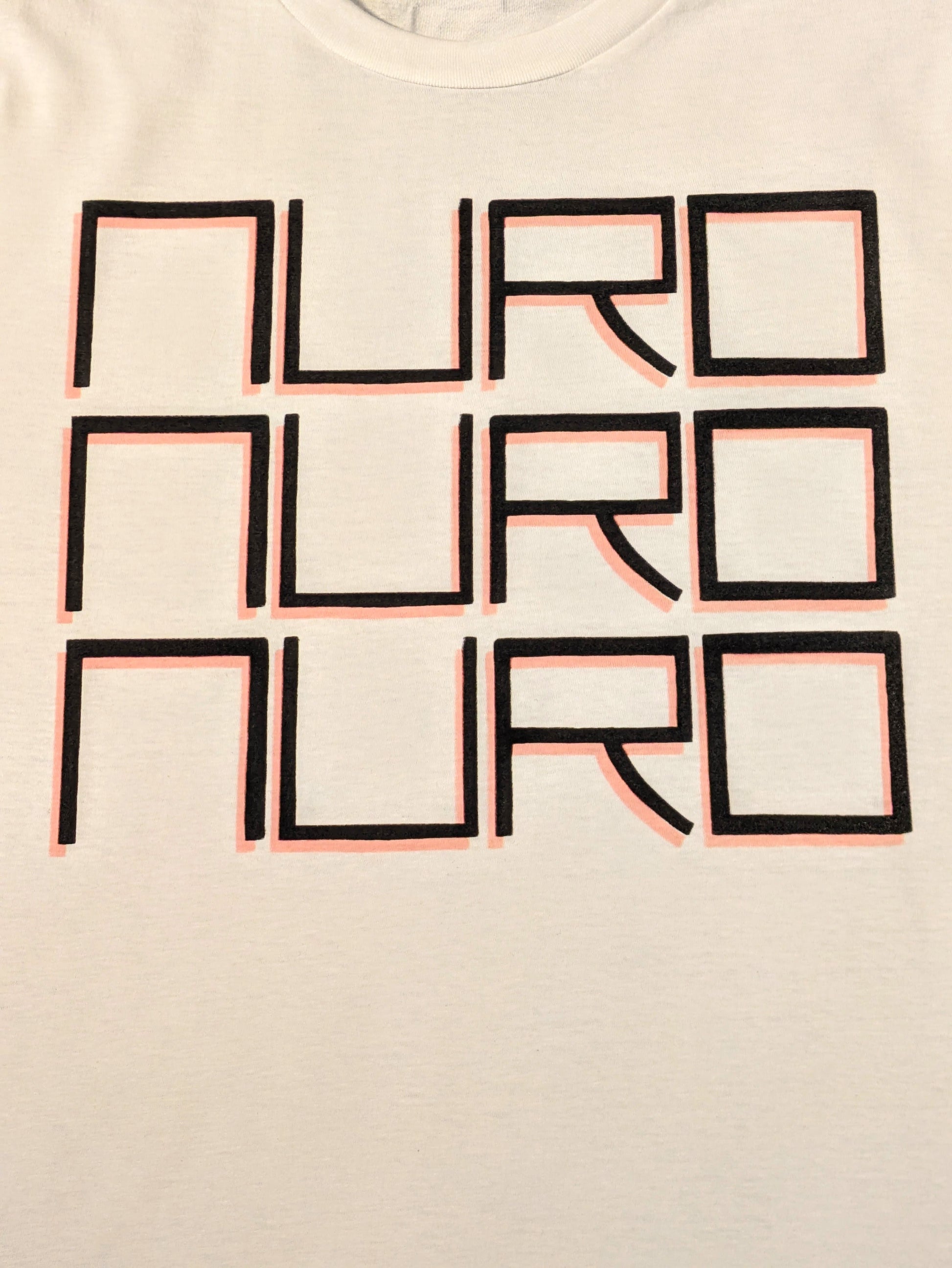 White tee with NURO printed three times vertically in fine block lettering with a light red dropshadow